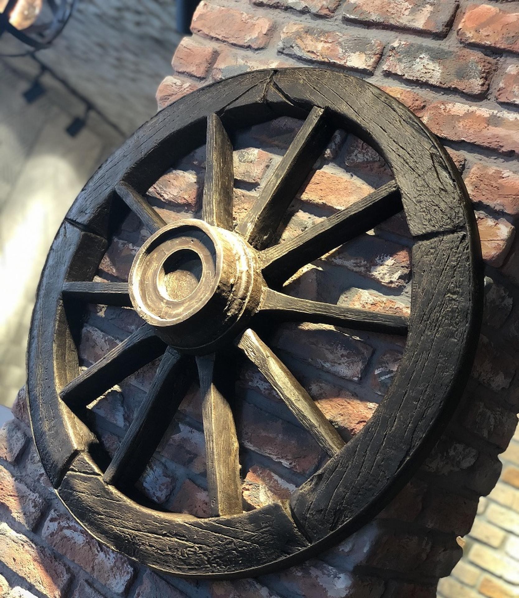 Polure P1950 decorative polyurethane wood-look wheel mounted on a rustic red brick wall with industrial spotlighting.