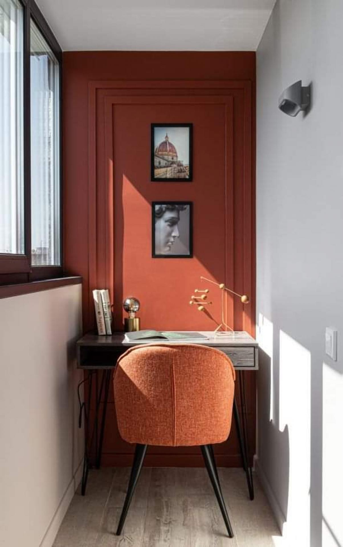 Ufficio moderno con parete terracotta decorata con modanature geometriche in poliuretano Polure P851350 e luce naturale.