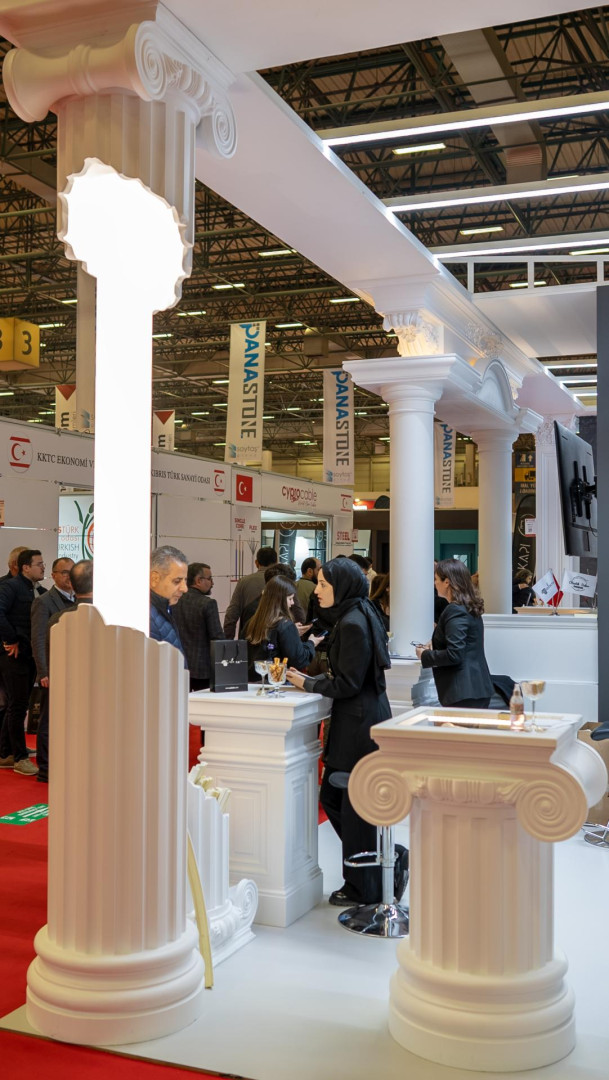 Stand fieristico moderno con colonne ioniche Polure in poliuretano, fusti scanalati P5250I e arcate decorative.