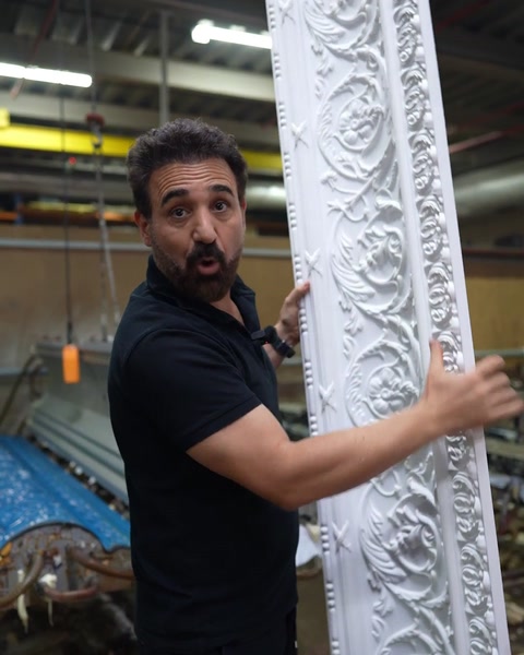 Hand runs along rose rosette pattern on freshly demoulded cornice
