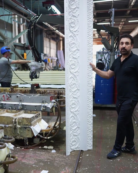 Full length cornice standing upright next to production benches