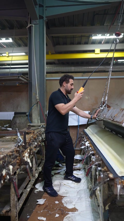 Operator guides crane pendant to raise upper half of aluminium mould