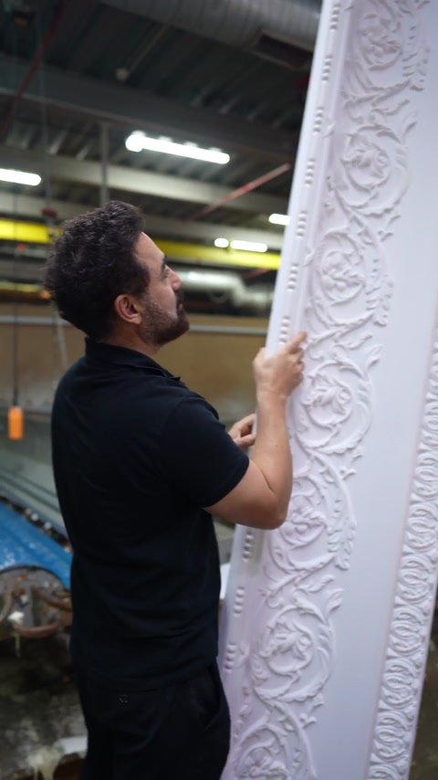 Close look at acanthus scroll relief running along cornice face
