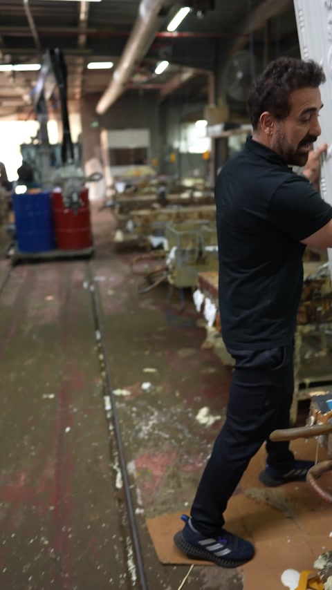 Presenter walks along injection line between mould tables
