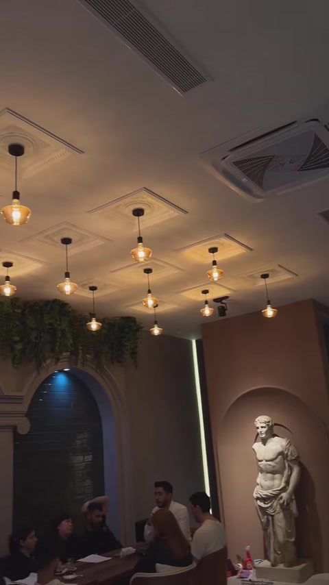 Hall designed with geometric ceiling trim and arched wall panels