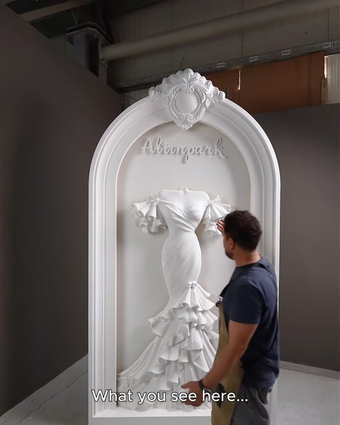 Assembled polyurethane arch with wedding-dress relief inside a factory setting.