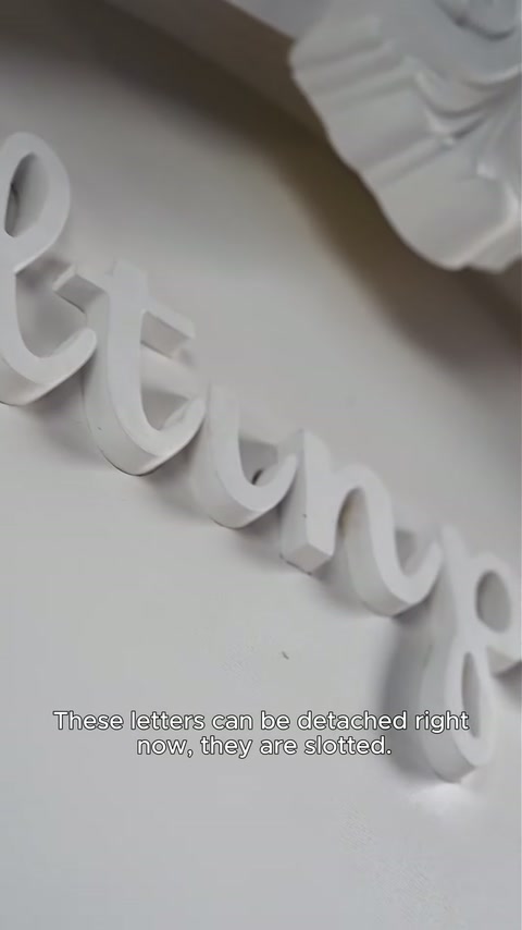 Raised script lettering appears partially separated from the recessed panel channel.