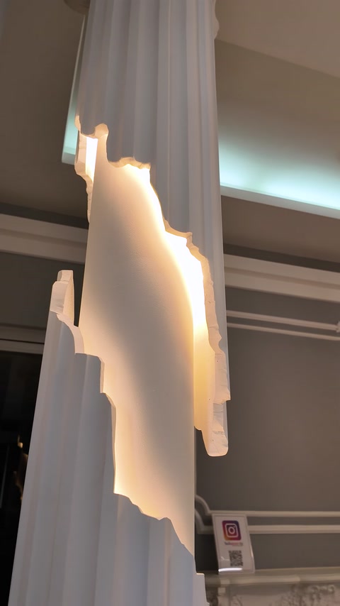 Backlit cove lighting profile glowing white against ceiling in showroom