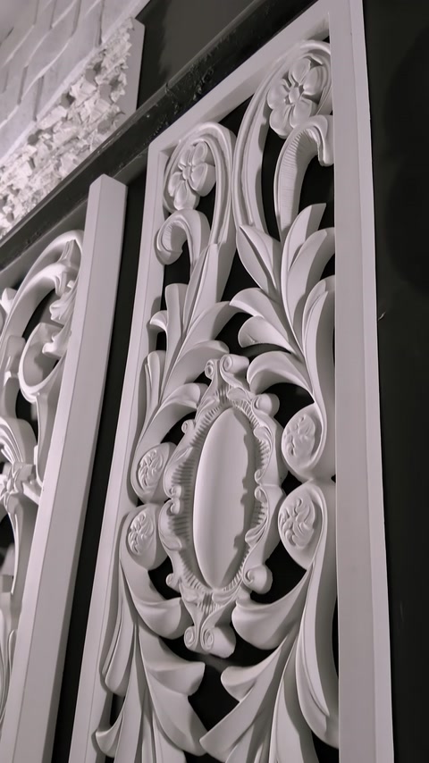 Carved decorative wall panel with intricate floral relief pattern close-up