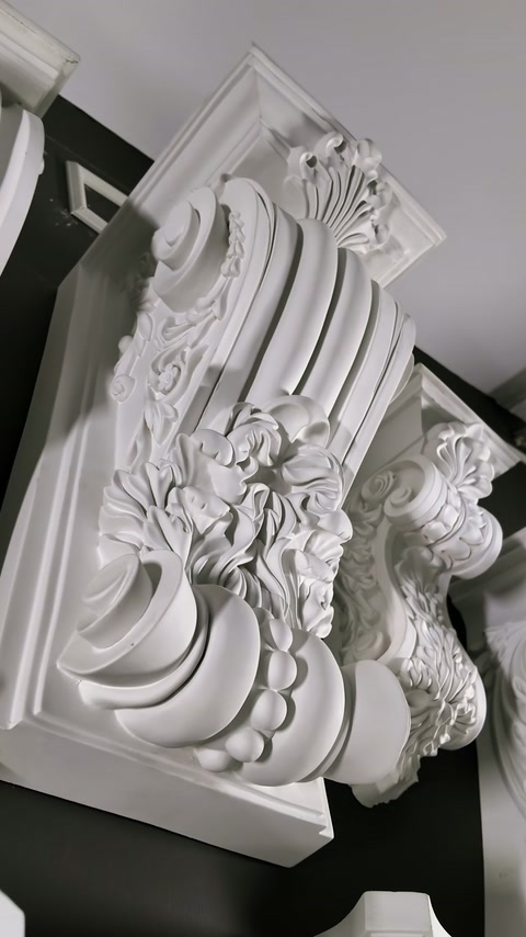 Stacked ornate corbels reveal layered floral and scroll relief details.