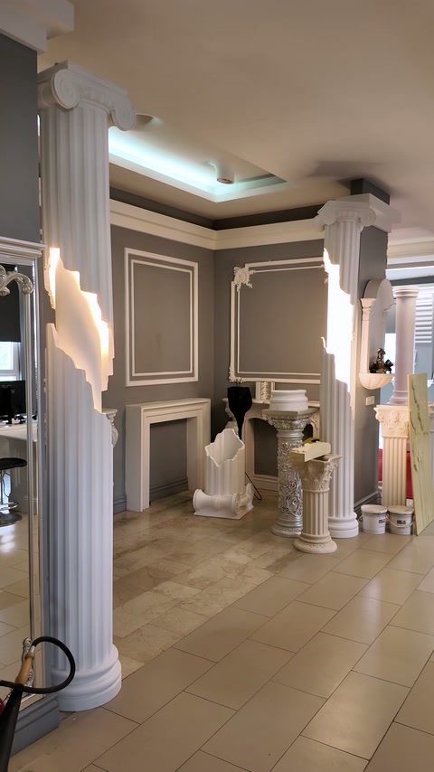 Decorative columns frame a showroom interior with moulded wall panels.
