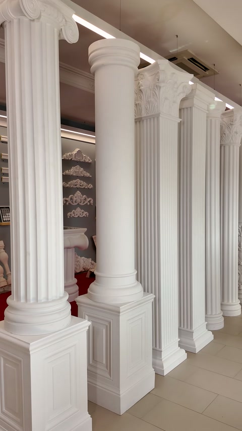 Tall classical columns display fluted shafts, capitals, and square bases.