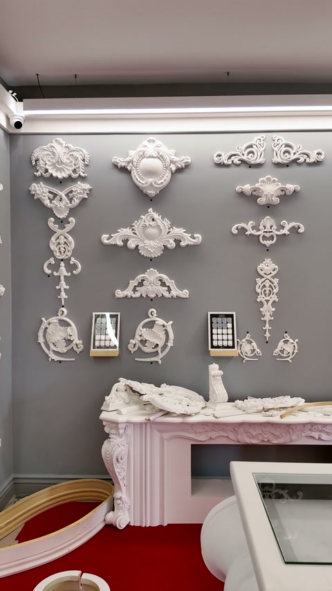 Symmetrical wall ornaments are arranged above an ornate fireplace surround.