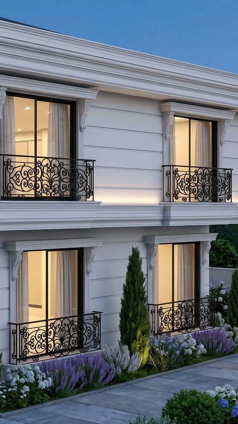 Illuminated facade with wide surrounds and horizontal belt courses framing windows