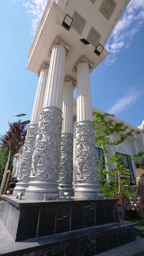 Decorative embossed columns rising before the entrance soffit