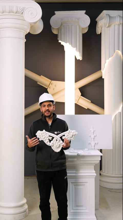 Esperto mostra il motivo in rilievo simmetrico frontalmente nell'area espositiva delle colonne