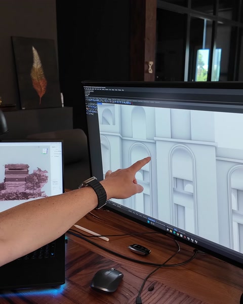 Designer examines details in the arched façade module on screen.