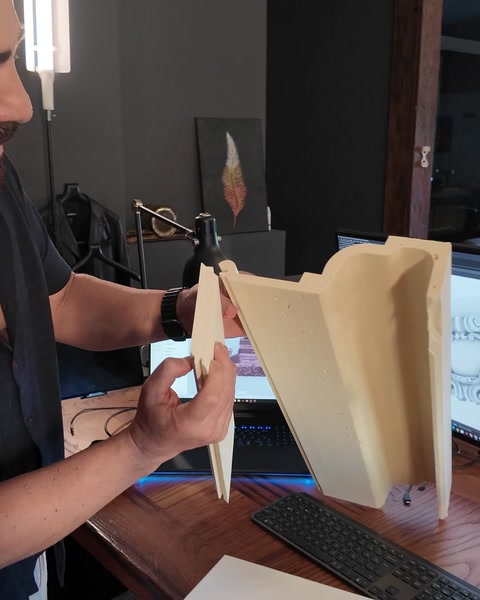 Cross-section of manufactured polyurethane corner profile examined by hand.