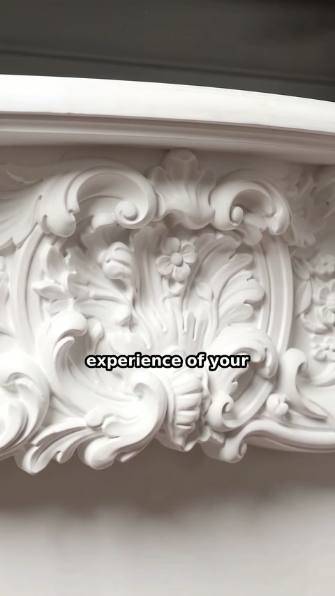 A tight view highlights floral scrollwork across the fireplace mantel center.