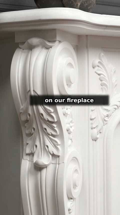 Carved volutes and vertical foliage ornament the side of the surround.