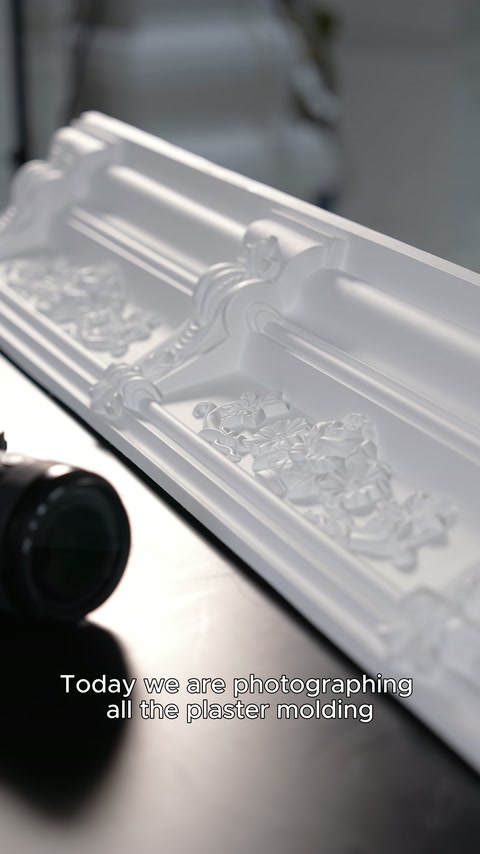 Patterned polyurethane cornice displayed in close-up next to the camera