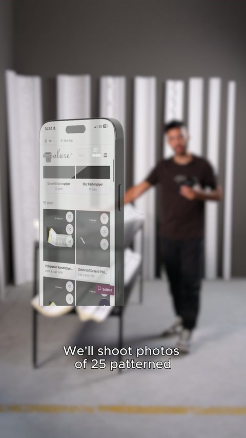 Product page displayed on phone screen in front of presenter in studio