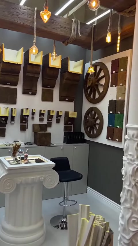 Decorative corbel samples and wheel-shaped ornaments are displayed on the wall