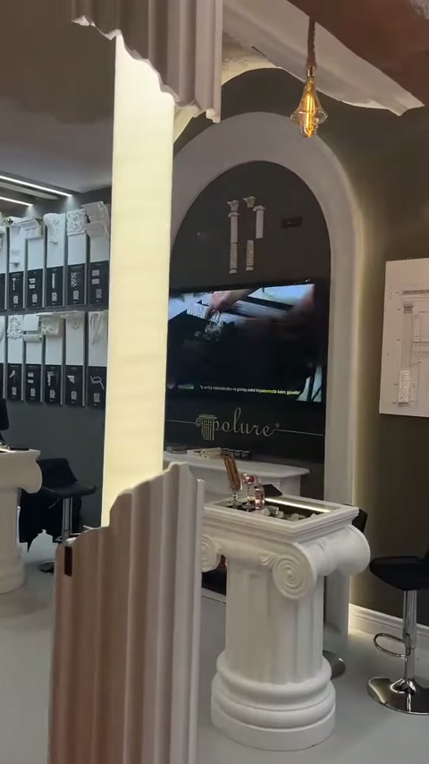 Decorative door surrounds around arch and column-shaped stand furniture on display