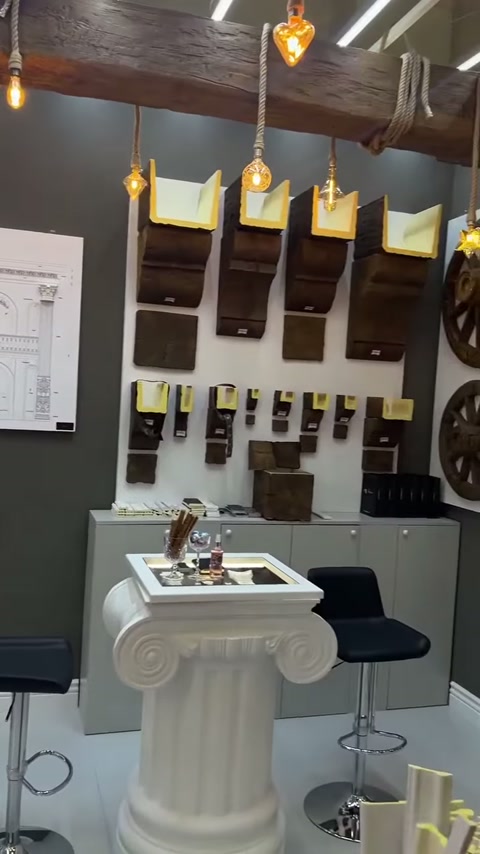 Pendant lighting overhead with console samples and fluted display table