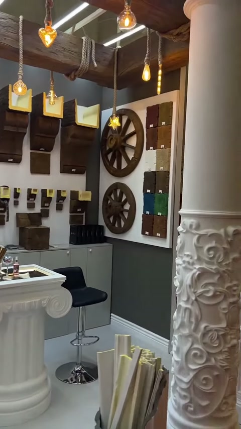 Consoles, small profile pieces and circular ornaments displayed along the wall