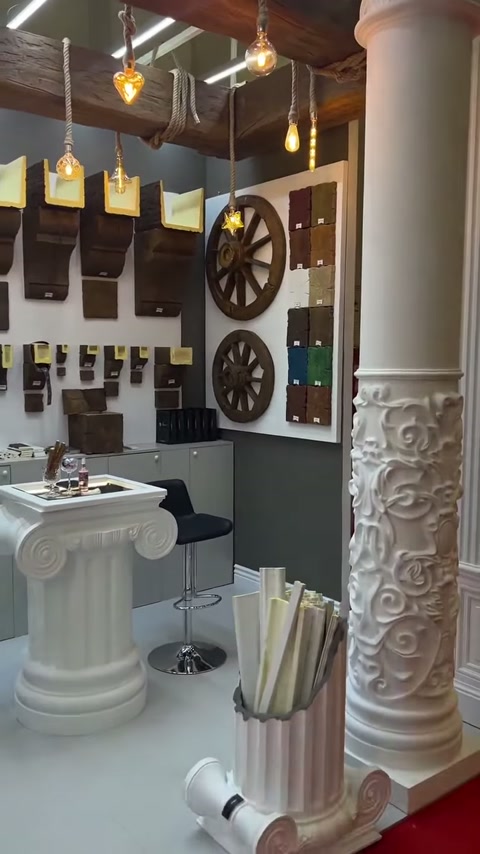 Carved-pattern column seen with console examples and decorative wheel ornaments