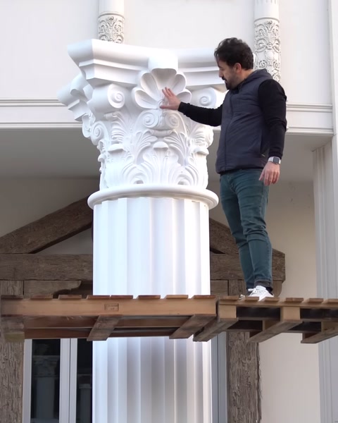 Platformda duran kişi sütun başlığının yanında duruyor