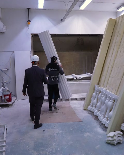 Manager and worker enter polyurethane spray painting booth area