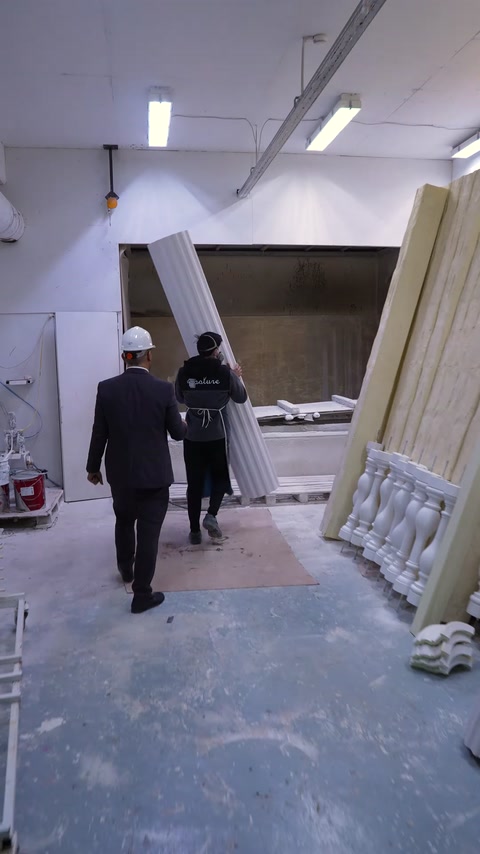 Manager and worker enter polyurethane spray painting booth area