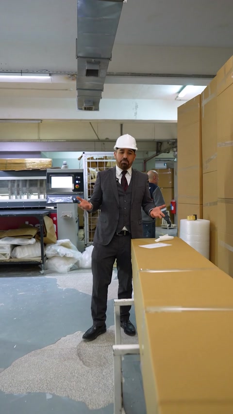 Manager stands near packaged polyurethane product ready for shipping