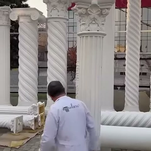 L'artigiano si avvicina alla zona dove si trovano i pezzi decorativi posati a terra