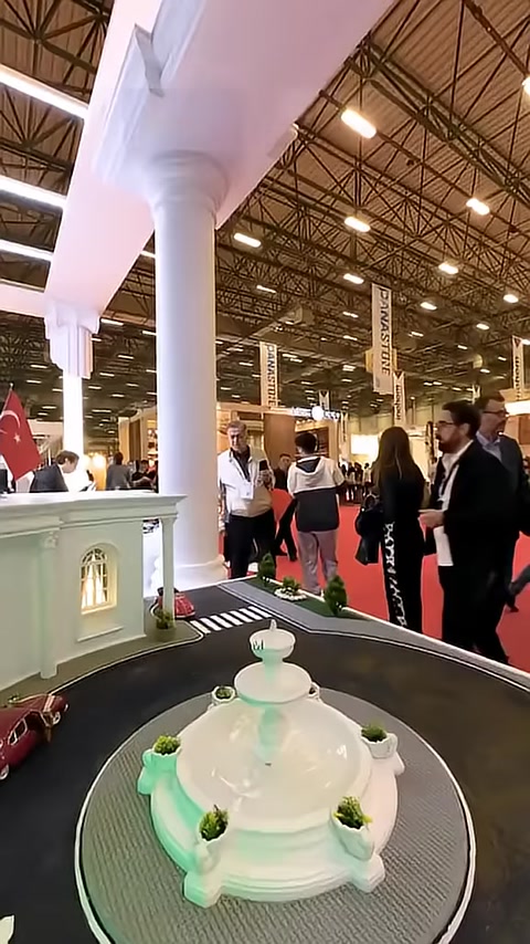 Budma fuar alanında sütunlarla çevrili dekoratif stand düzeni görülüyor