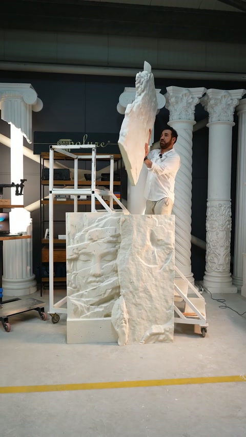 Installer raises a tall narrow relief section behind the grouped panels.