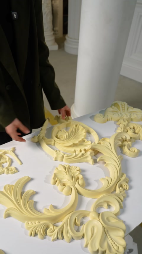 Ceiling ornaments in different forms are seen together on a table