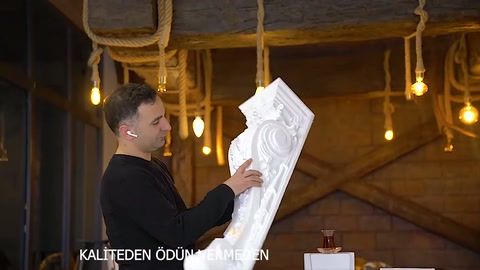 Long decorative column rotated to present different surface angles to viewers