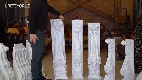 Presenter reaches toward a long model among the arranged columns