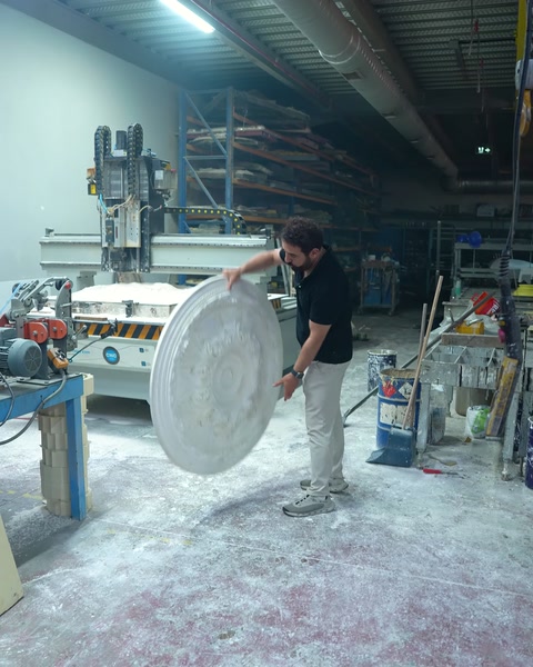 Worker holding a round ceiling medallion in hand