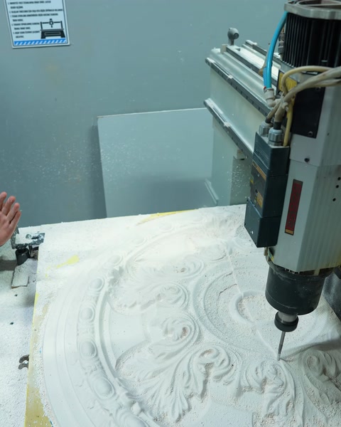 Close-up shot of the CNC milling bit machining the ceiling medallion pattern