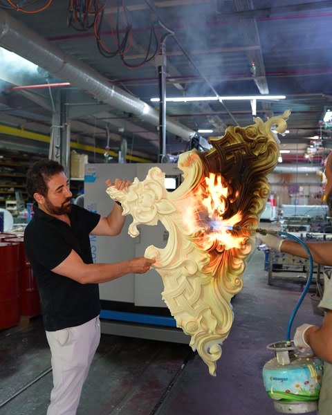 Two workers performing a fire test on a polyurethane piece