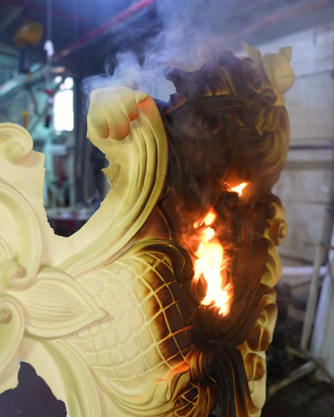 Close-up of a small flame on the piece with the ceiling medallion pattern