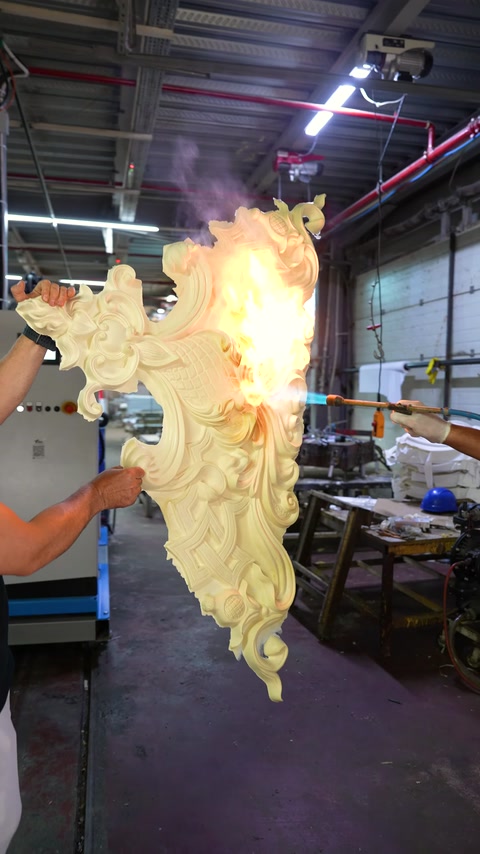 A polyurethane decorative piece with carved patterns is seen up close during a flame test.