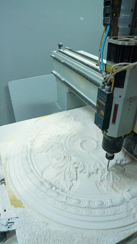 The CNC milling machine machines curved motifs into the circular ceiling medallion mold.