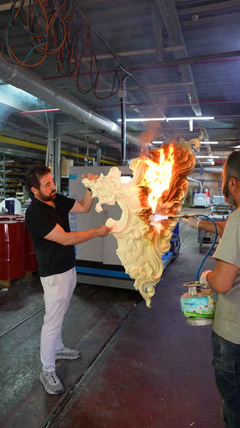 A flame test is conducted on a decorative piece with carved patterns in the workshop.