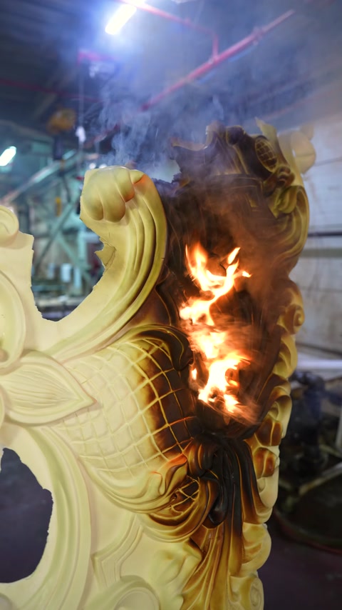 Burning and darkening are visible along the edge of the decorative piece during the flame test.