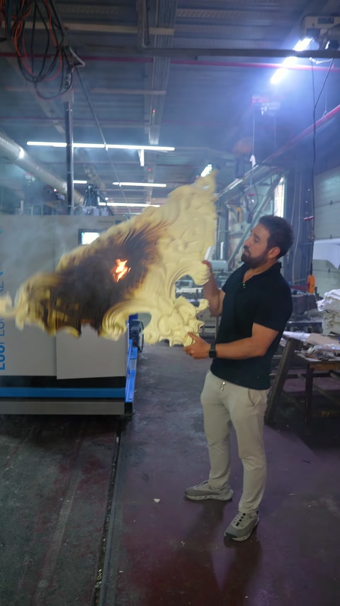 The tested decorative piece and rising smoke are visible in the workshop.